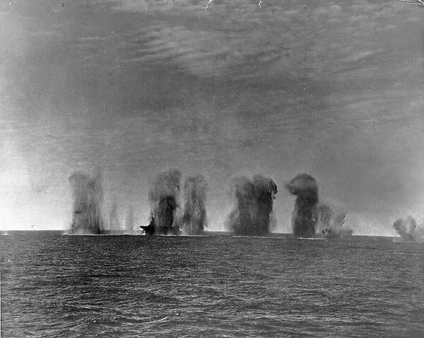 Bombs falling all around of HMS Ark Royal during an attack by Italian aircraft during
