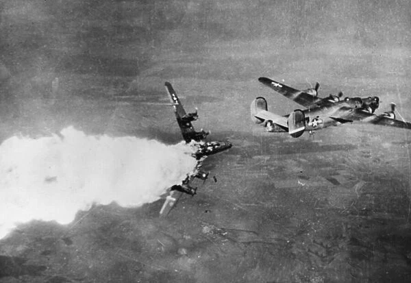 Bombs tumble from the bays of an overturned Liberator Bomber of the 15th Air Force