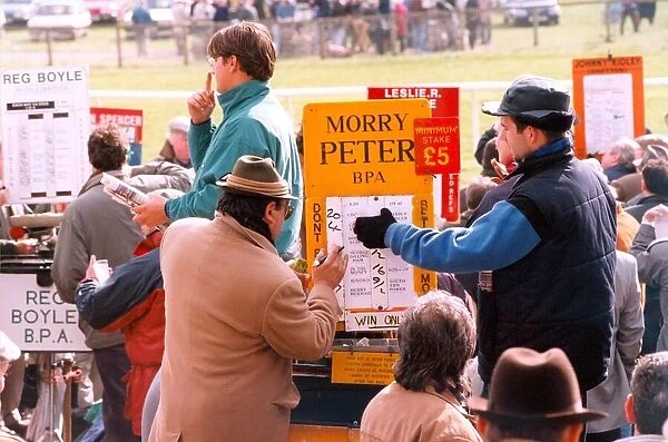 A bookie changing the odds at the racetrack in April 1995