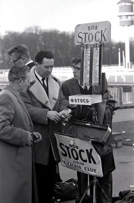 Framed Print : Bookmakers checks his takings after bets were placed for the race March 1963