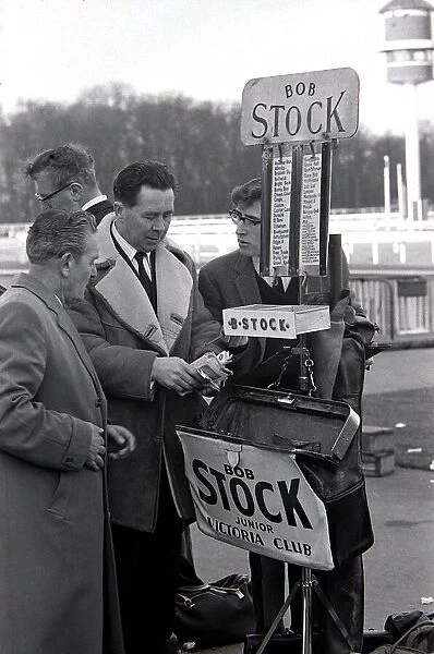 Bookmakers checks his takings after bets were placed for the race March 1963