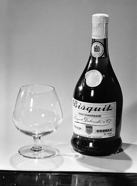 Bottles of wines and spirits with glasses. 1959 D69-006