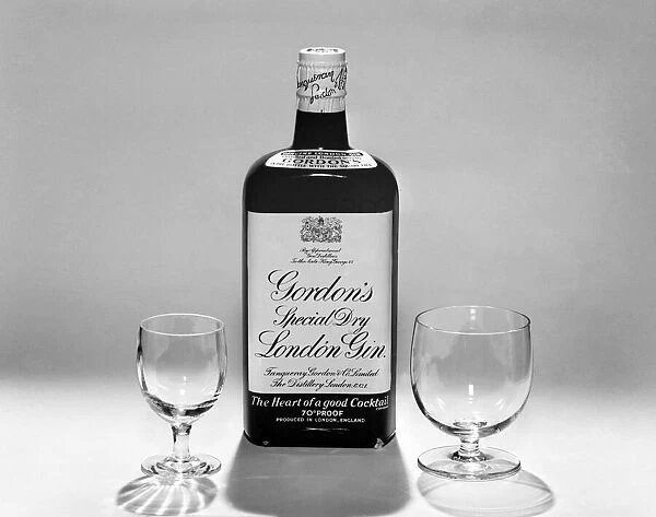 Bottles of wines and spirits with glasses. 1959 D69-009