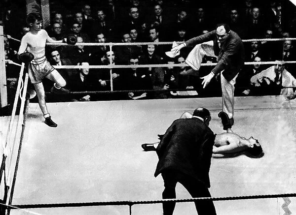 Boxer Benny Lynch in ring with fallen opponent who is being counted out
