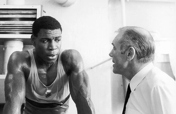 Boxer Frank Bruno with his trainer. 22nd April 1984