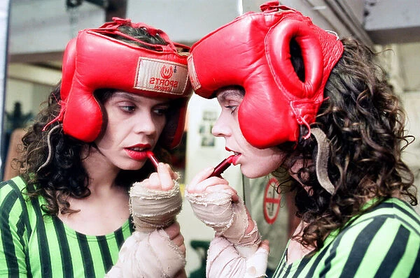 Boxer Pauline Dickson applying lipstick in the changing rooms of her boxing gym