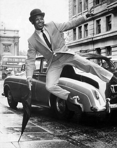 Boxer Sugar Ray Robinson doing an impression of Sammy Davis Junior dressed in a city