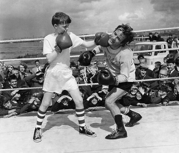 Boxer: Walter Mcgowan seen here in the ring during a training bout with a young admirer