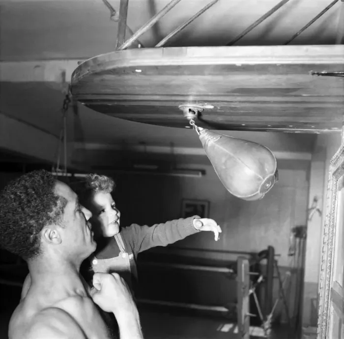 Framed Print : Boxing. Boxer Alex Buxton seen here holding his son Punching ball. May 1953 D2547
