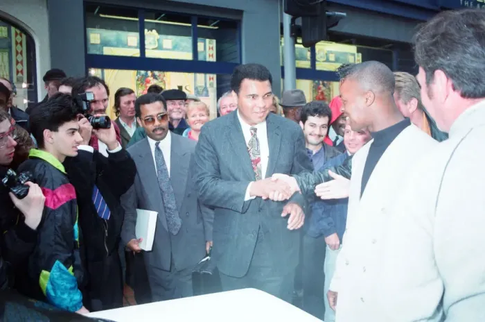 Framed Print : Boxing fans queue outside Dillions book store in Birmingham seen here greeting Muhammad Framed Print : Boxing fans queue outside Dillions book store in Birmingham seen here greeting Muhammad