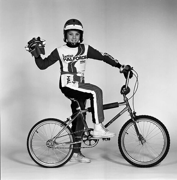 A boy with a BMX bike and wearing a BMX outfit. 25th November 1983