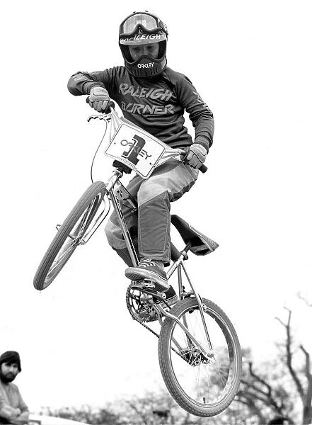 A boy doing stunts on his BMX cycle