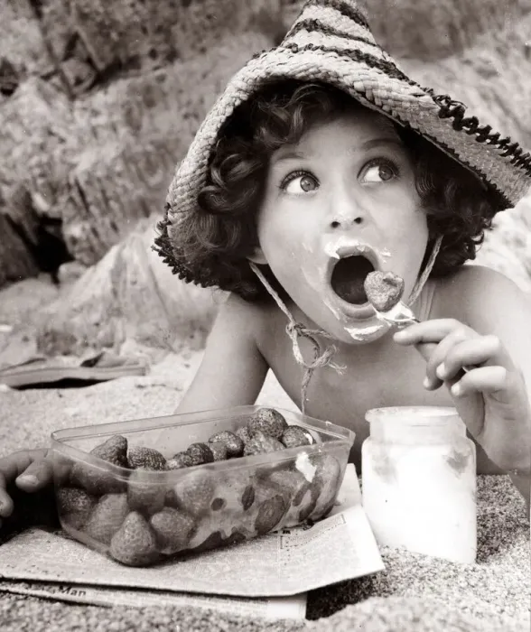 Framed Print : Boy eating strawberries on a beach, circa 1950 Framed Print : Boy eating strawberries on a beach, circa 1950