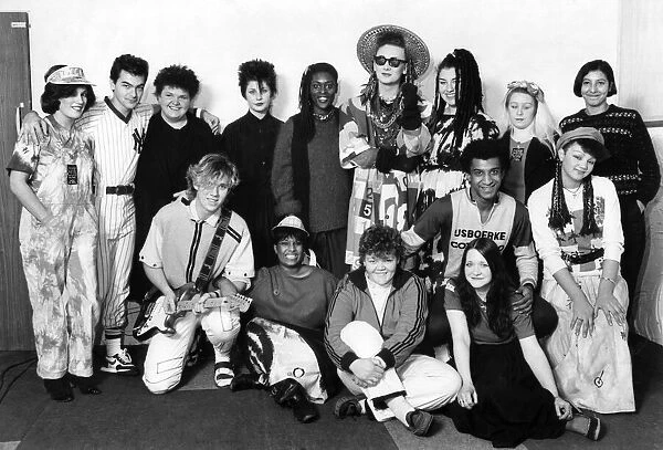 Boy George and his group Culture Club with pose with female fans