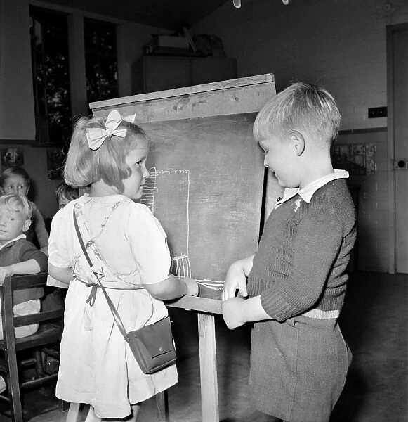 A boy and girl seen here painting at the Barley Park Day Nursery in Leeds