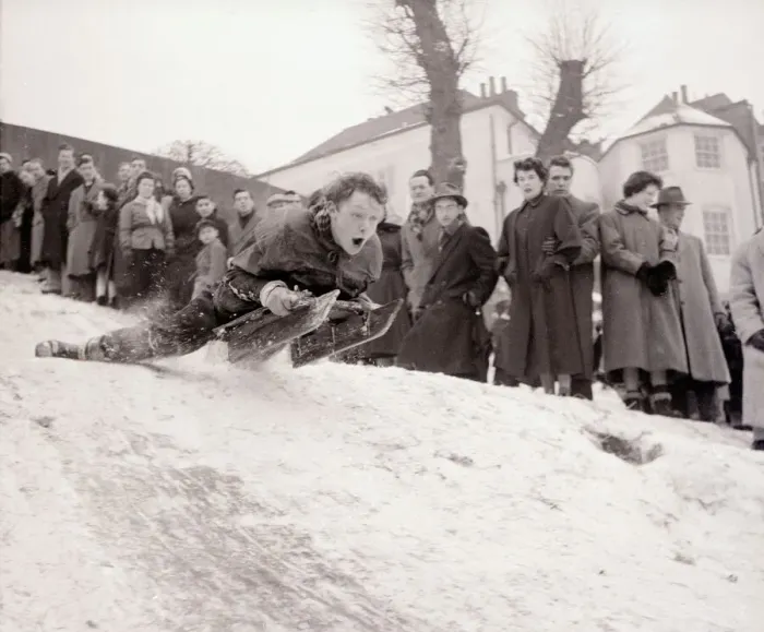 Framed Print : A boy goes flying down a snow covered hill on a sledge at Hampstead Heath February