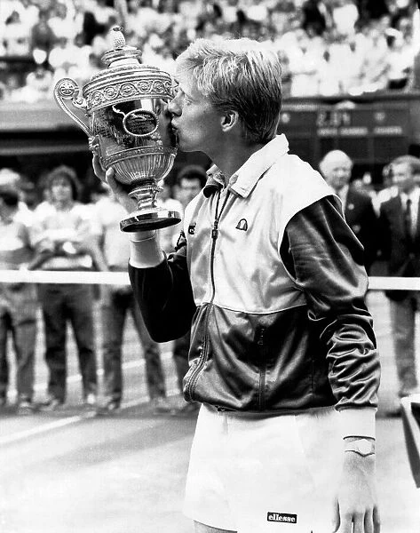Boy king Boris Becker plants a smacker on the championship trophy