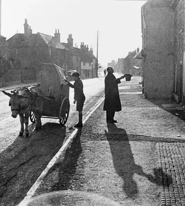 Framed Print : A boy operates a barrel organ mounted on a donkey and cart Framed Print : A boy operates a barrel organ mounted on a donkey and cart