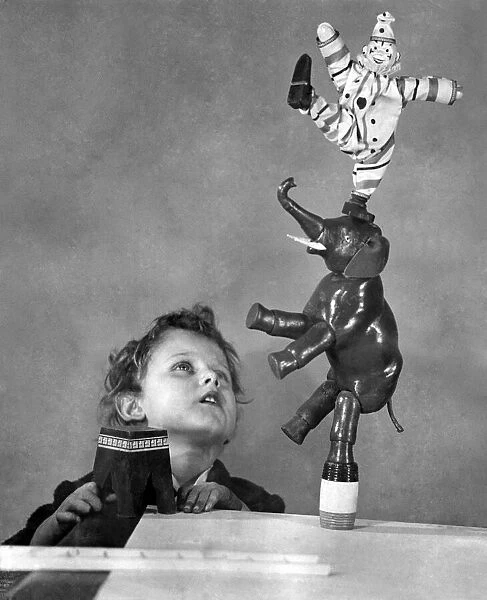 Boy playing with Humpty Dumpty Circus toys for Christmas December 1924