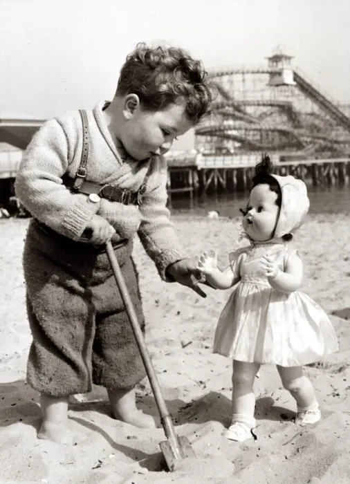 Framed Print : Boy plays with doll on the beach Cute kid on holiday at the seaside Framed Print : Boy plays with doll on the beach Cute kid on holiday at the seaside