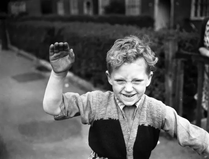 Framed Print : A boy plays on his tricycle on a council estate as his mother looks on 1955 Framed Print : A boy plays on his tricycle on a council estate as his mother looks on 1955