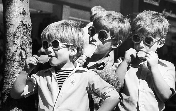 Three boys keep their cool with an ice lolly in Coventry City Centre