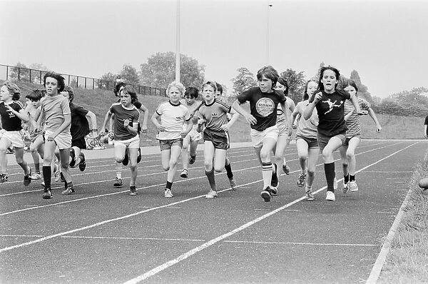 Boys and girls take part in a race at their school sports day. 20th June 1979