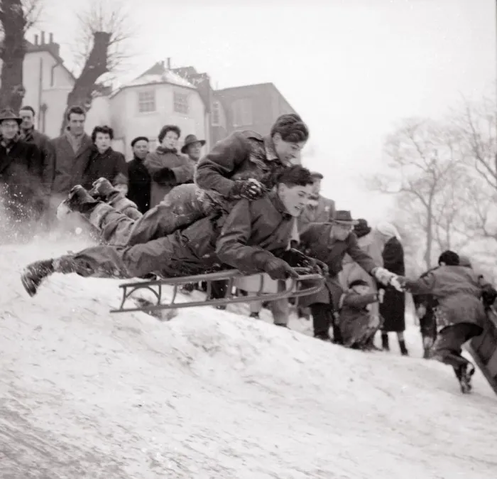 Framed Print : Boys goes flying down a snow covered hill on a sledge at Hampstead Heath February