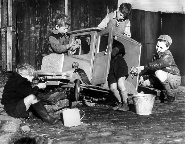 Boys polishing a model van owned by Norman McKeown. 11th November 1952