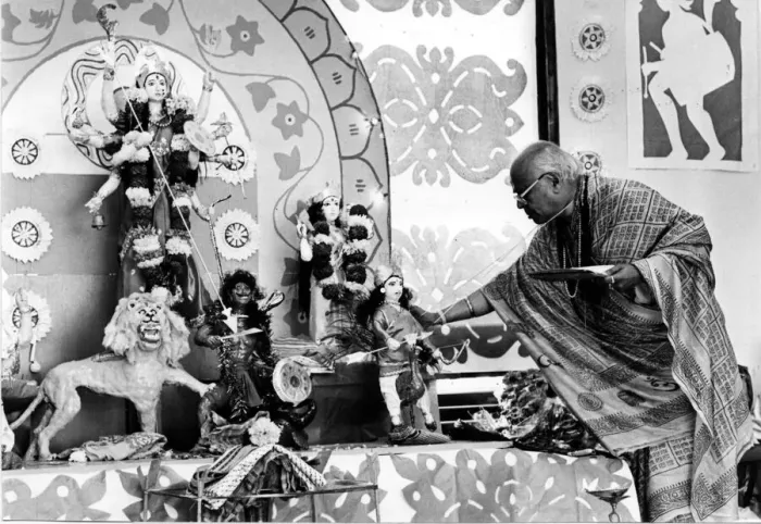 Framed Print : Brahmin priest Mr R. P. Bannerjee at the alter of the goddess Durga during the most