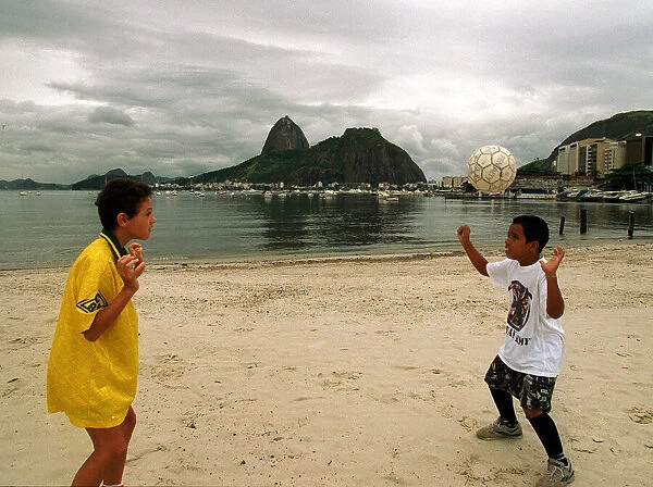 Brazil World Cup feature, May 1998. Football mad children play on the beach in Rio