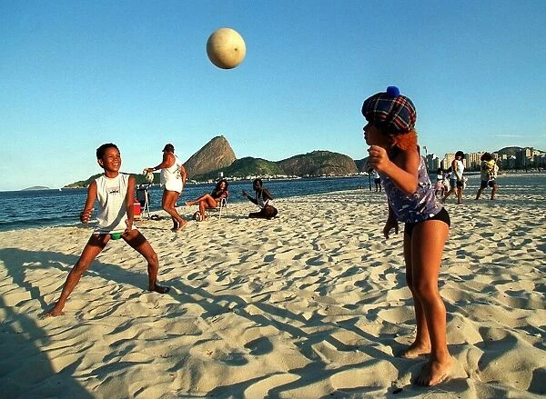 Brazil World Cup feature May 1998 Rio De Janeiro football mad children play on beach with