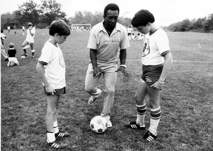 Framed Print : Brazilian football star Pele ashowing off his skills to American youngsters at his soccer Framed Print : Brazilian football star Pele ashowing off his skills to American youngsters at his soccer