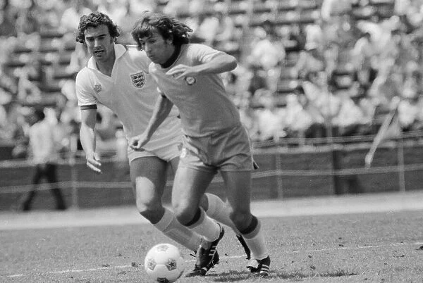 Brazilian football star Zico in action against Terry Butcher of England during the two