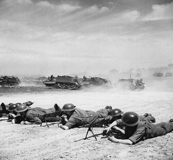 Bren carriers in action while the carriers pass in the background. 25th June 1941