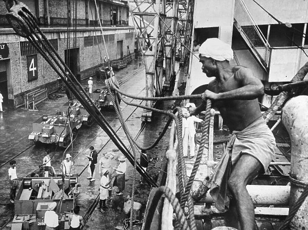 Bren gun carriers being swung on to Rangoon docks. Burma