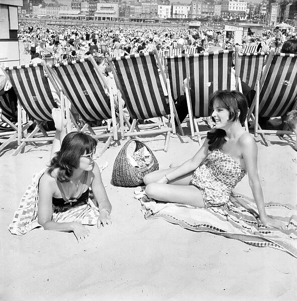 Brenda Waller (left) and her sister Carol on the beach at Margate in Kent during a hot