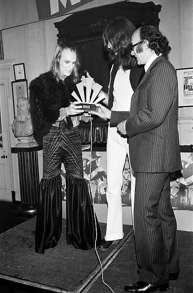 Brian Eno holding receiving his award at The Oval Pop Festival, Oval Cricket Ground