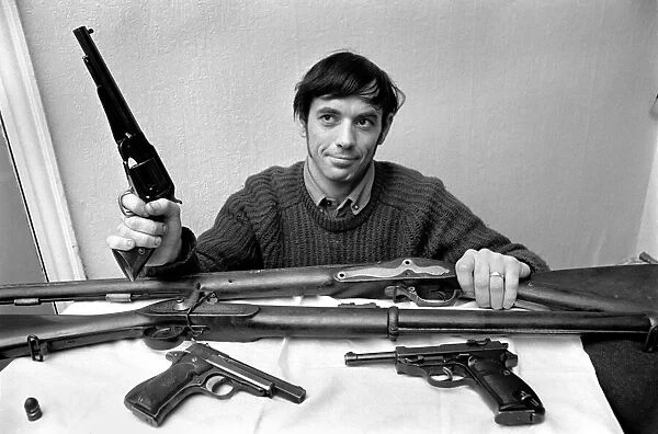 Brian Entwistle with his son, Nigel (5) and his collection of guns - a hand-reproduction