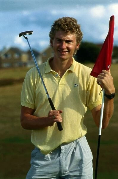 Brian Whittle holding golf club and flag August 1989