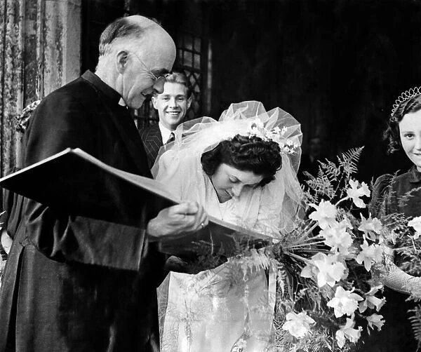 This bride forgot to sign the register. The Rector, Canon Whytehead hurried after