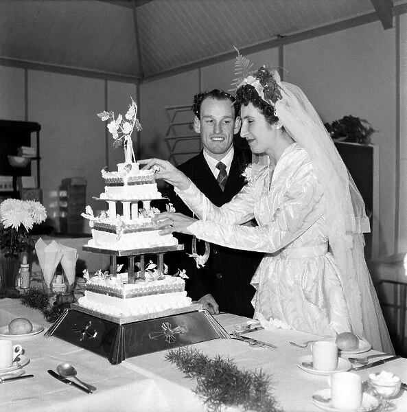 The bride and groom cut the cake. October 1953 D6213