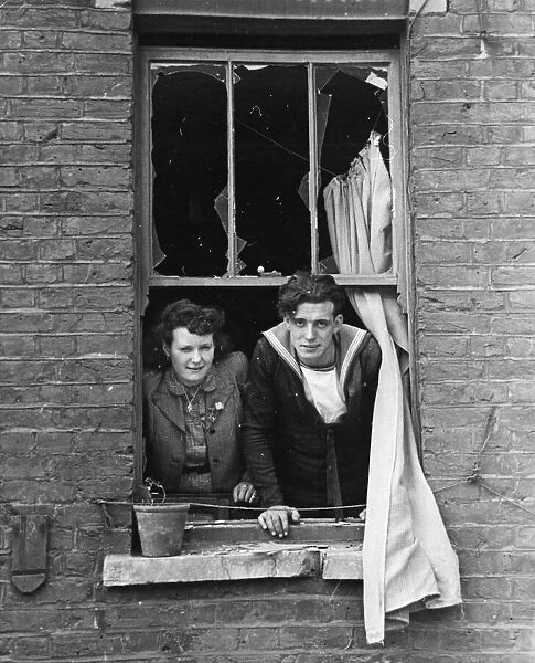 The bride and Royal Navy groom look out of their window, onto where a bomb recently fell