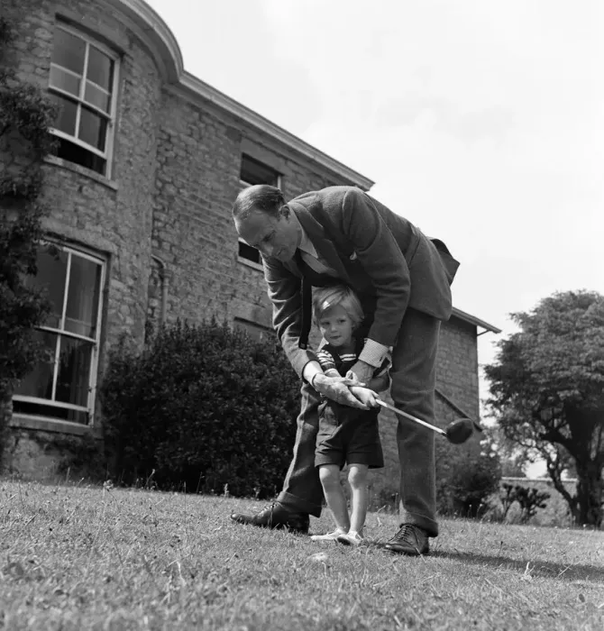 Framed Print : Brigadier Fitzroy Maclean playing with his son Charles in their garden at home in Yealand Framed Print : Brigadier Fitzroy Maclean playing with his son Charles in their garden at home in Yealand