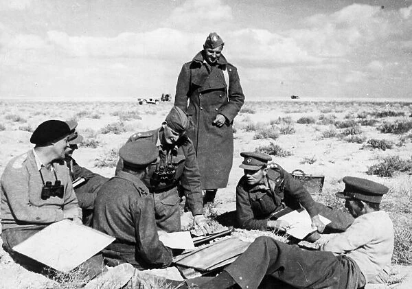A Brigadier and other officers hold a conference in the Western Desert during the British