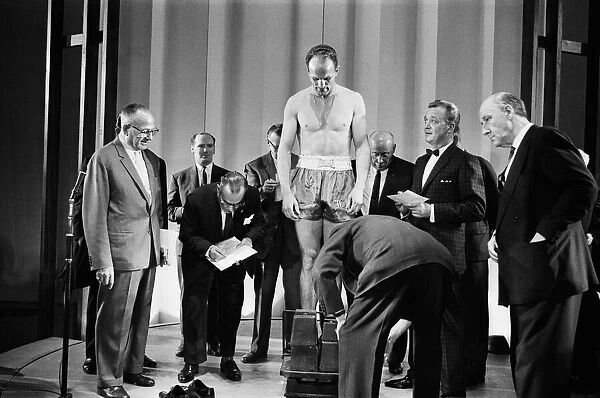 Britains Henry Cooper weighs-in for his non title bout against Cassius Clay aka