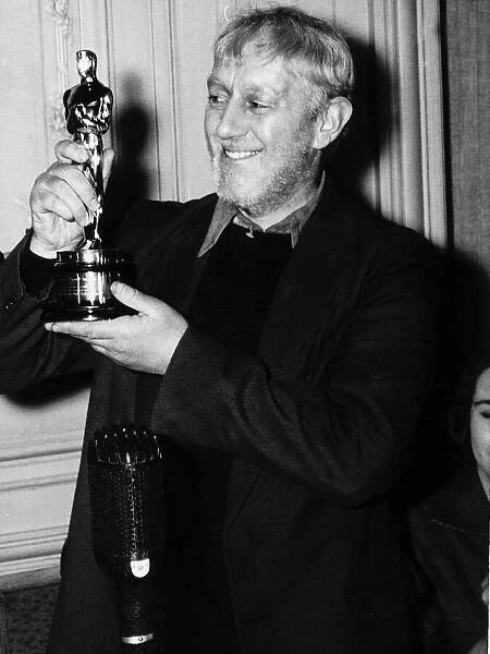 British actor Alec Guinness holding an Oscar 1958