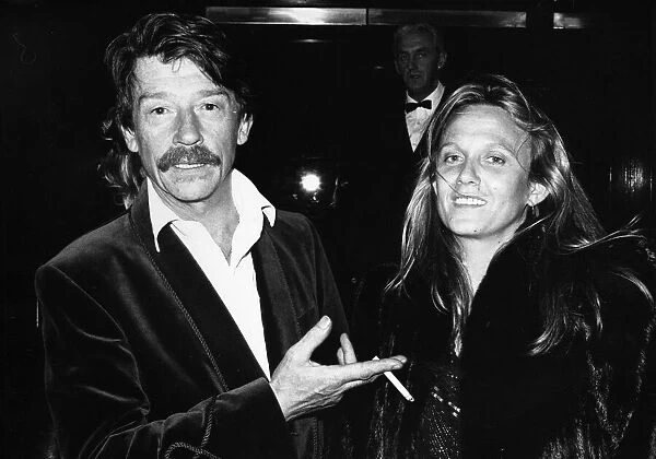British actor John Hurt arrives at the Royal Albert Hall in London with his wife Donna to