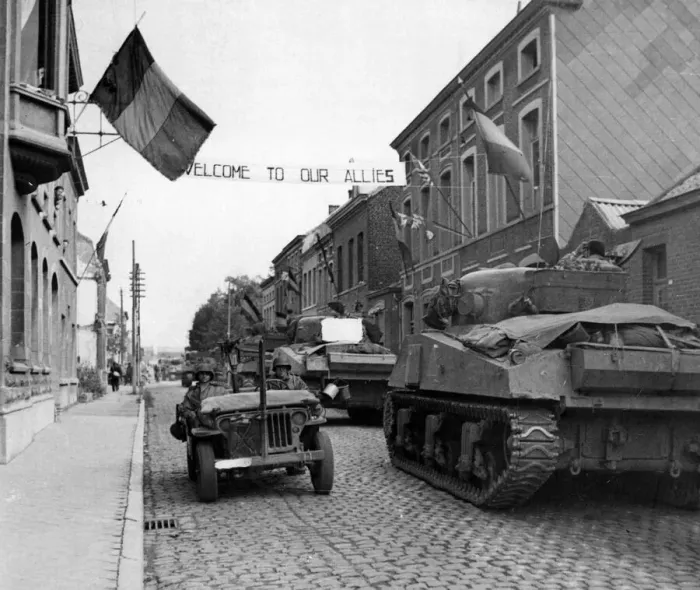 Framed Print : British advance in Belgium. A banner across a road in Antoing reads Framed Print : British advance in Belgium. A banner across a road in Antoing reads