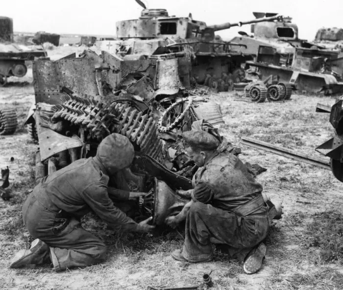 Framed Print : British army engineers remove the bearing from a wrecked vehicle in a dump which has